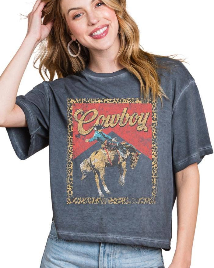Woman wearing a graphic t-shirt with a horse and text design on a white background